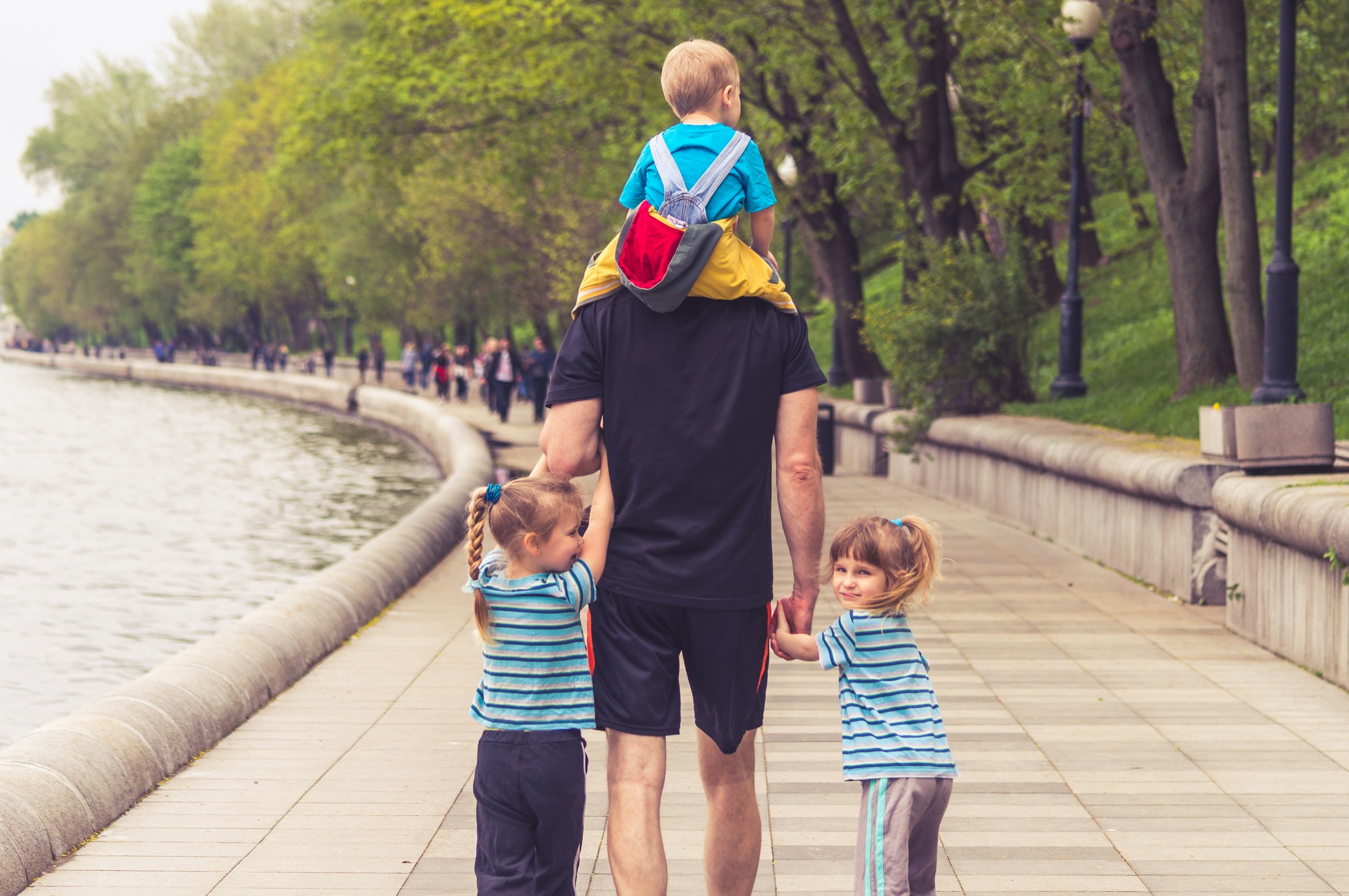 A family walking together beside the water