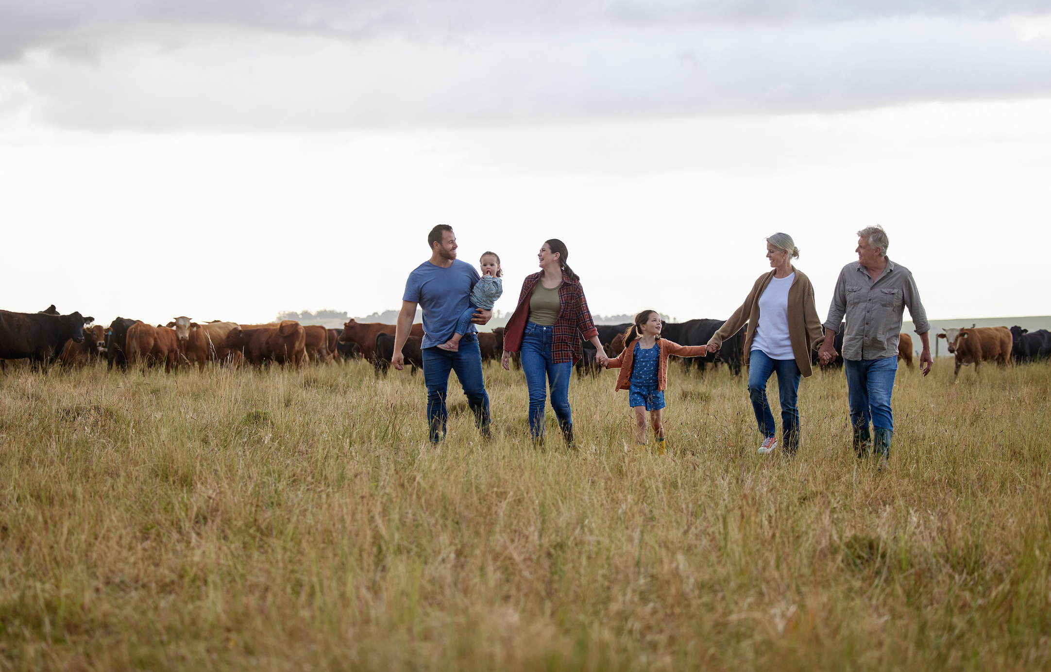 A family walking together across a rural field